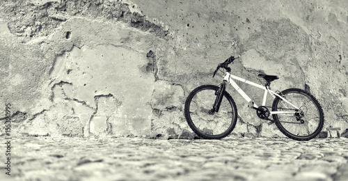 Bicycle near a stone wall