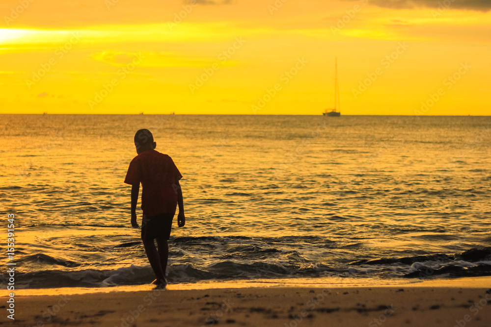 Beach Boy on sunset background