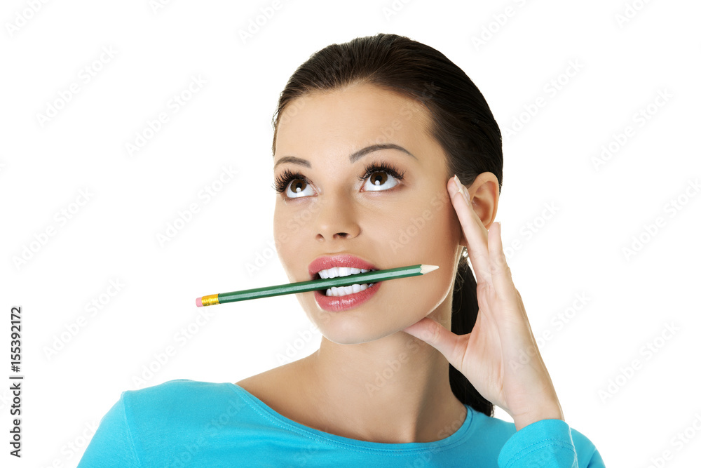 Thoughtful attractive student woman biting pencil Thoughtful attractive student woman biting pencil