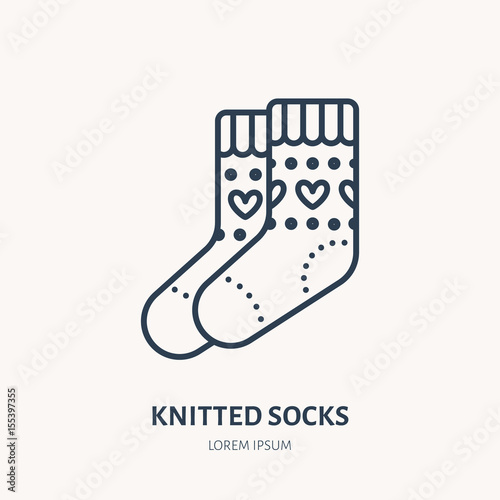 Illustration of woolen socks. Knitted clothing shop line logo. Vector flat sign for atelier or garment shop.