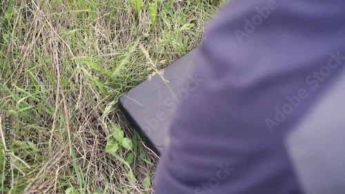 Male opening box-case and reloading a gun on a field shooting