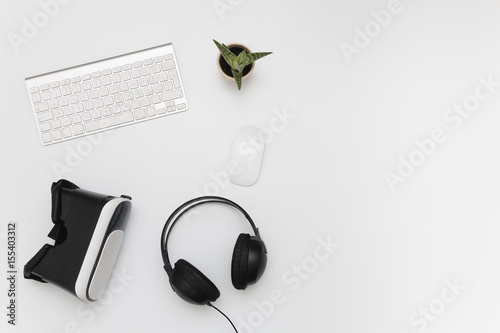 Grey Desk with VR Glasses, Headphones, Keyboard, Mouse, Fat Plant and Espresso Coffee Mug