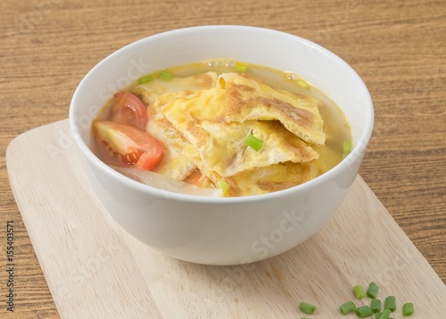 Thai Omelet Soup on A Wooden Board