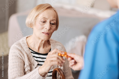 Frail fragile mature woman having the pills prescribed