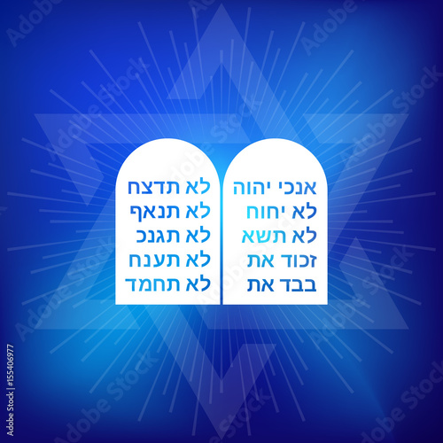 Rock of ten commandments with Hebrew alphabet on blue background with star of David and ray of light