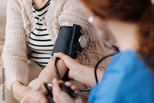 Cuadro en lienzo Observant competent doctor diagnosing her elderly patient