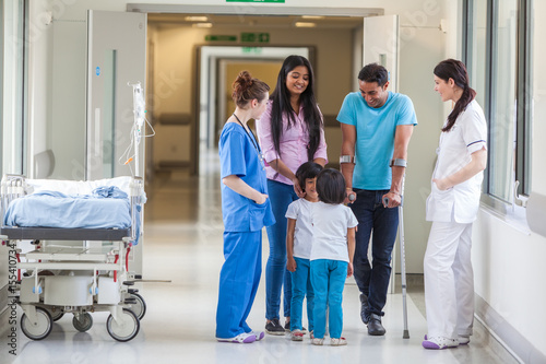 Asian Indian Family, Doctor and Nurse in Hospital Corridor