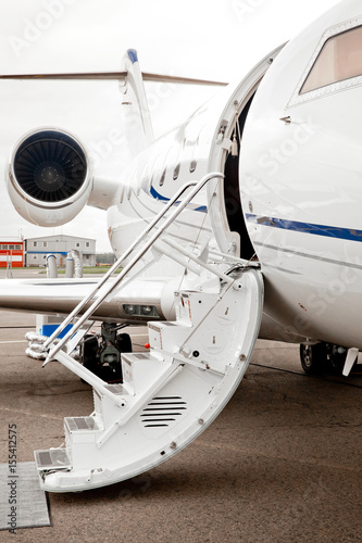 Ladder trap and open door to business jet airplane