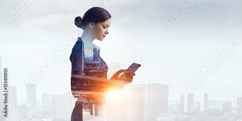 Attractive business lady working on tablet