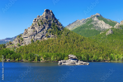 High scaur Okzhetpes and mysterious sphinx Zhumbaktas (puzzle-stone) on Lake Auliekol (Borovoe) are located in Burabay National Nature Park in the Republic of Kazakhstan. Beautiful mountain landscape. photo