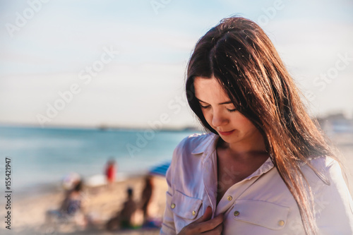  Beautiful woman,posing in boho style beach dress near the sea