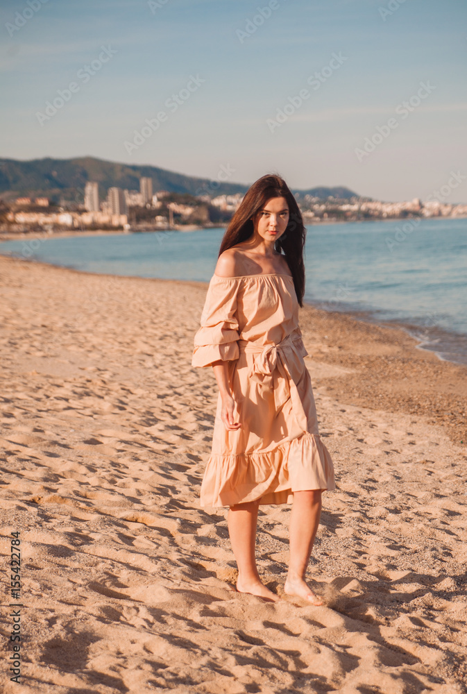 Beautiful woman,posing in boho style beach dress near the sea Beautiful woman,posing in boho style beach dress near the sea