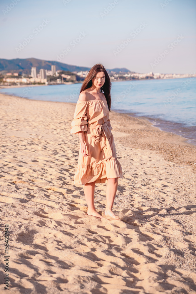 Beautiful woman,posing in boho style beach dress near the sea Beautiful woman,posing in boho style beach dress near the sea