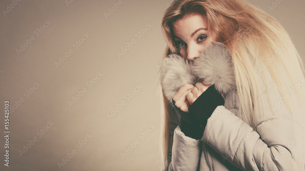 Happy woman wearing winter warm furry jacket