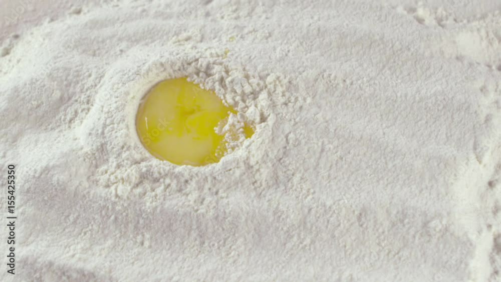 Adding an egg to a hill of flour Adding an egg to a hill of flour
