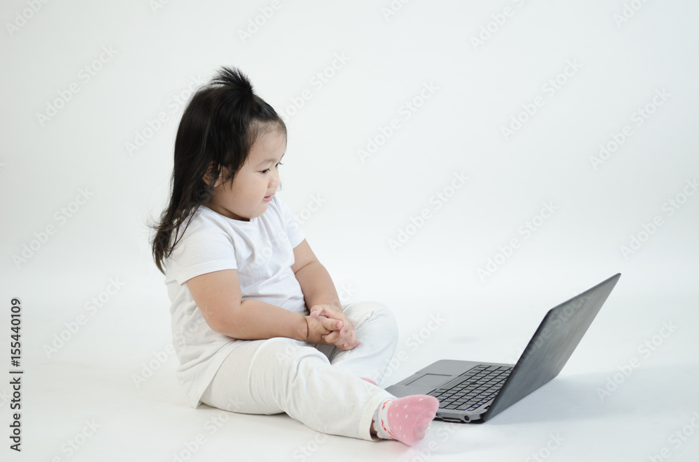Asian child playing on computer laptop