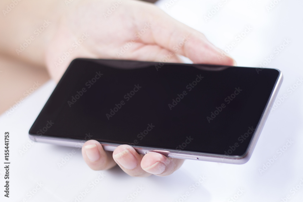 Hand holding mobile smartphone with blank screen. Hand holding mobile smartphone with blank screen.