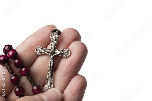 Rosary and cross in hand isolated on white background
