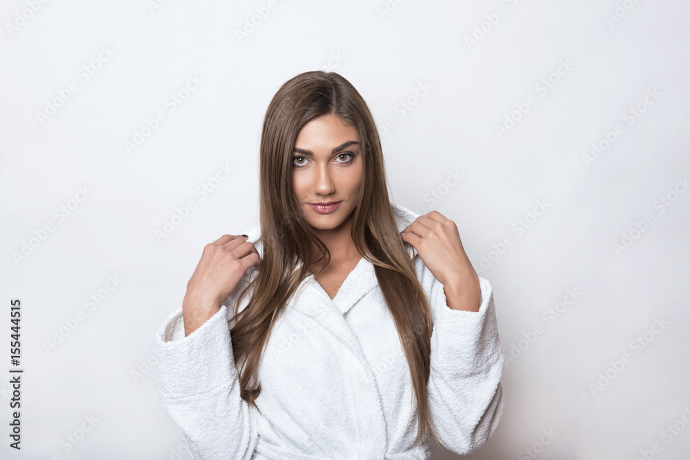 beautiful young woman with long hair wearing white bathing robe beautiful young woman with long hair wearing white bathing robe