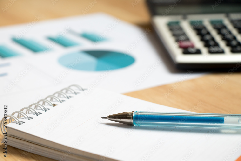 Note paper with pen, graph, calculator background Note paper with pen, graph, calculator background
