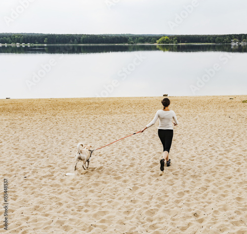 woman with dog and lake 