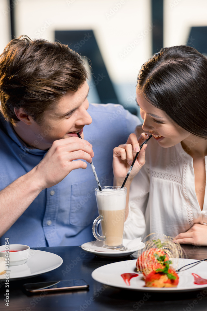 Beautiful happy young couple in love at romantic date in restaurant Beautiful happy young couple in love at romantic date in restaurant
