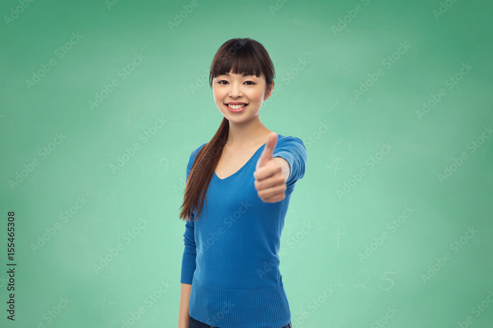 happy smiling young woman showing thumbs up