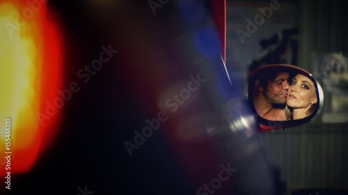 Car love couple kiss reflection in the mirror photo