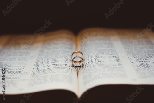 Two wedding rings on a book page
