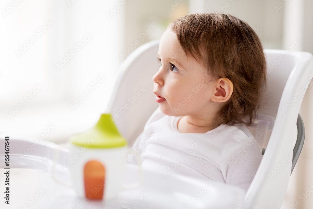 happy baby girl sitting in highchair at home happy baby girl sitting in highchair at home