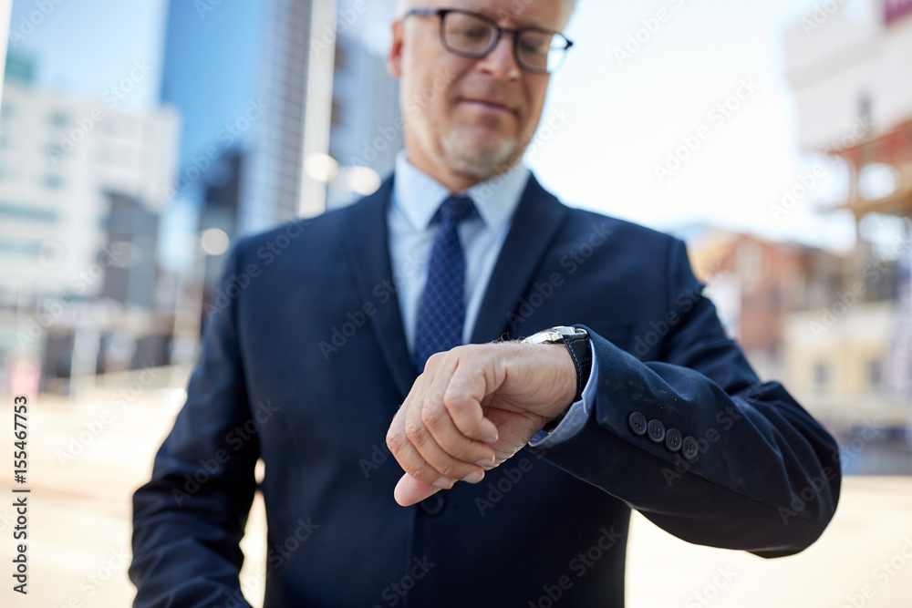 senior businessman with wristwatch on city street senior businessman with wristwatch on city street