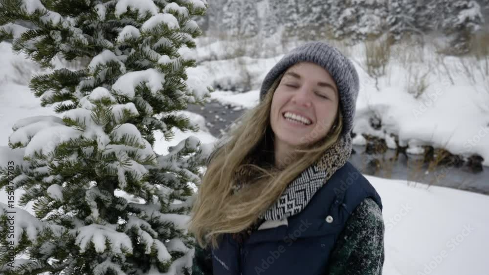 Portrait Of Young Woman Smiling And Laughing, She Winks At Someone Off-Screen Portrait Of Young Woman Smiling And Laughing, She Winks At Someone Off-Screen