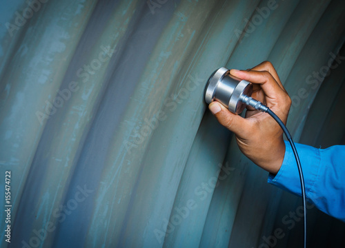 Inspector use ultrasonic testing machine for inspection defect in steel structure.