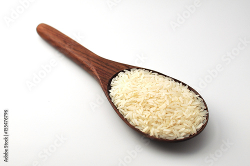 Uncooked rice, jasmine rice, mali rice,Thai jasmine rice in a wood ladle on white background.