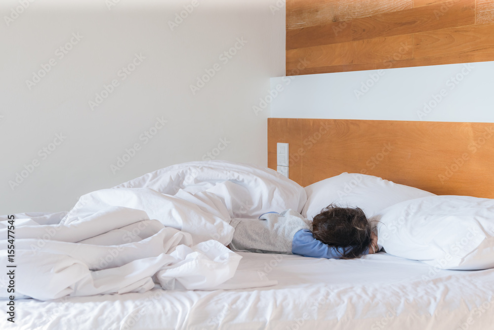 Baby sleep on Bed after nights,comfort and bedding in a hotel room, concept travel and vacation Baby sleep on Bed after nights,comfort and bedding in a hotel room, concept travel and vacation