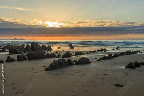 Sunset and Stone formations in Barrika Beach (Biscay). Nature elements concept