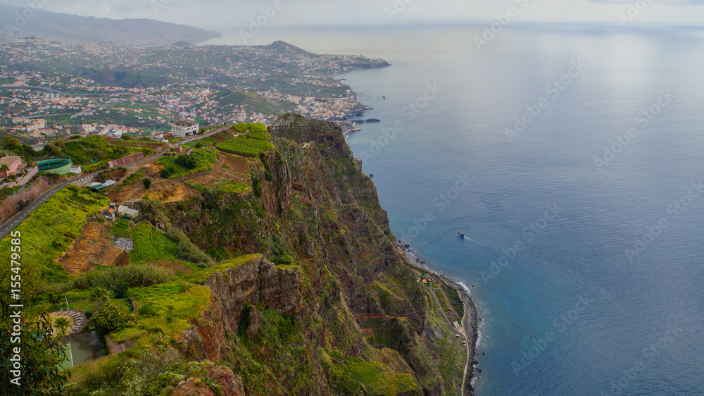 Madeira - Viewpoint Cabo Girao with view to the City of Funchal and green meadows above the ocean