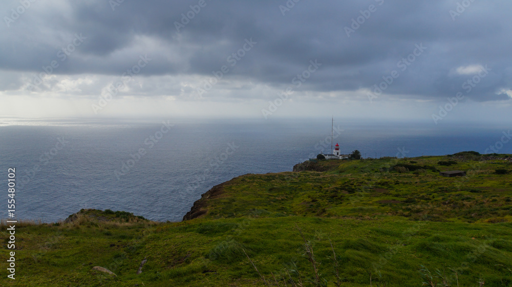 Madeira - Ponta do Pargo lighthouse behind green meadows at the coast