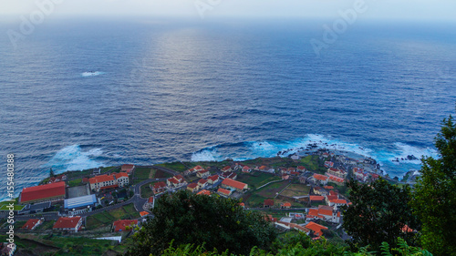 Madeira - View above the City of Porto Moniz and the ocean and some trees at dawn