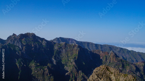 Madeira - Pico do Arieiro mountains with green rocks and clouds beneath