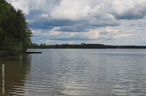 Gray storm clouds over the forest and lake. Pisochne ozero. Volyn region. Ukraine photo