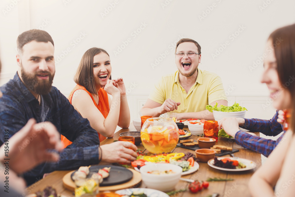 Group of happy people at festive table dinner party Group of happy people at festive table dinner party