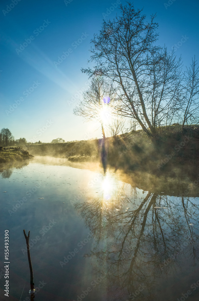 Fototapeta premium Morning mist on the river in spring, sunrise