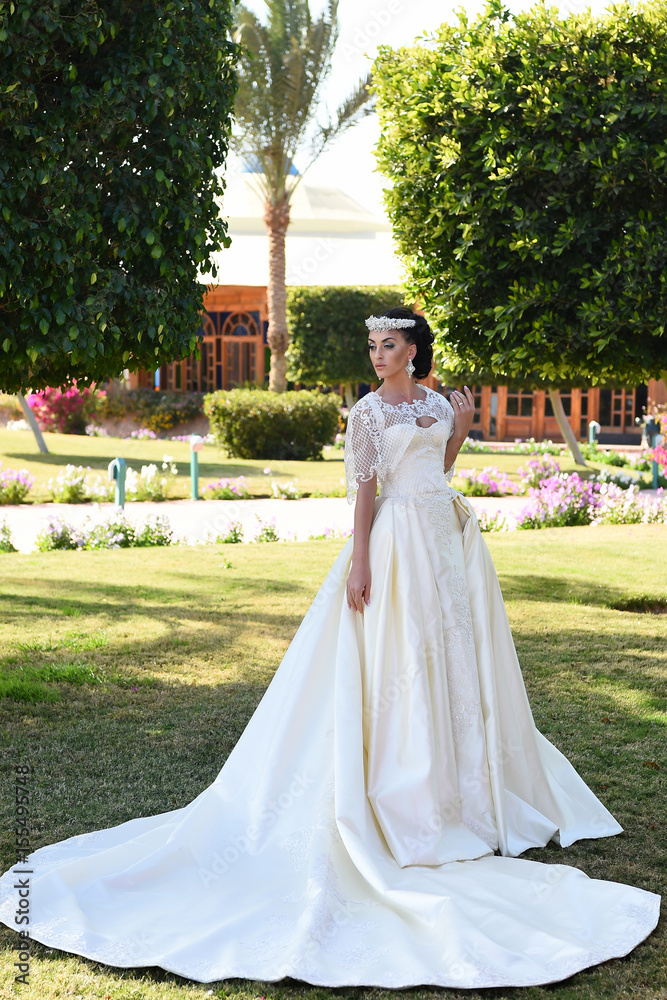 pretty woman in white wedding dress, fashionable makeup and hair