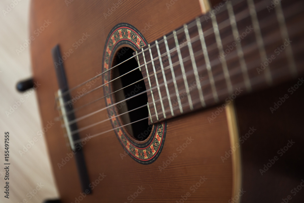 Fototapeta premium detail of classic guitar with shallow depth of field