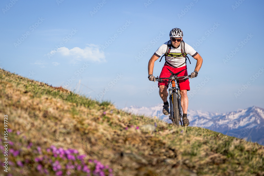 Fototapeta premium Male mountainbiker on a trail in the mountains