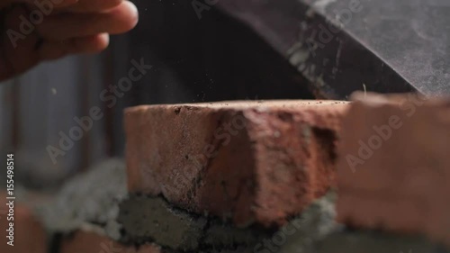 Strong man's hands building a house