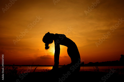 Young woman in a meditating yoga the beautiful sunset © nikomsolftwaer