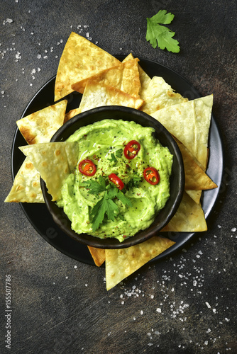 Avocado dip guacamole with tortilla chips.Top view with copy space.