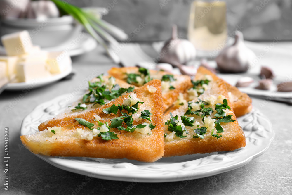 Tasty bread slices with garlic and herbs on plate Tasty bread slices with garlic and herbs on plate